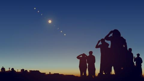 Image of people looking at the sky during a solar eclipse